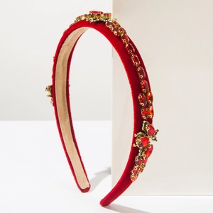 Detailed macro view of luxury red velvet headband featuring gold insect crystal ornaments