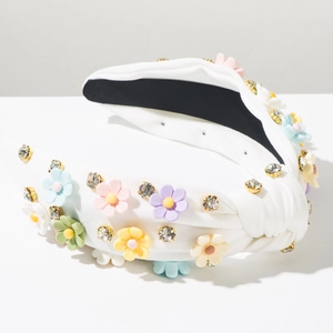 Detail of white knot headband with colorful 3D flowers and sparkling rhinestones
