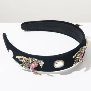 Close-up of vintage baroque headband with velvet fabric and crystal bird embellishments