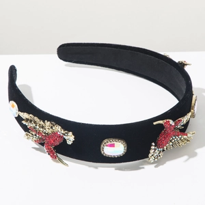 Detailed close-up of Baroque velvet headband with crystal hummingbirds and gemstones