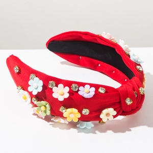 Close-up of red knotted headband featuring 3D colorful flowers and sparkling rhinestones