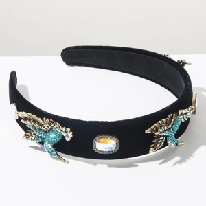 Detail view of Baroque headband with golden birds and blue rhinestones on black velvet