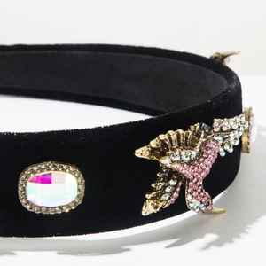 Detailed macro view of baroque headband with gold bird ornaments and crystal rhinestones