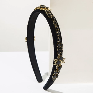 Detail of velvet headband with black rhinestones and golden bee metal ornaments