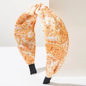 Detail of orange paisley print headband with twist knot and black protective ends