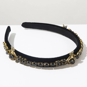 Detailed macro of Baroque velvet headband with gold insect motifs and black rhinestones