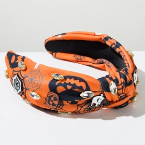 Detail of Halloween headband with pumpkin patterns and sparkling rhinestone embellishments