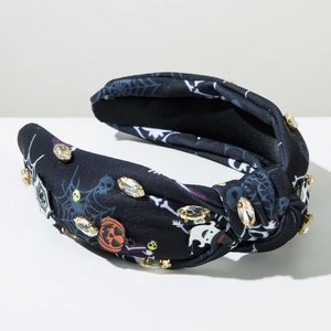 Detail of Halloween headband featuring rhinestone spider webs, pumpkins, and white ghosts