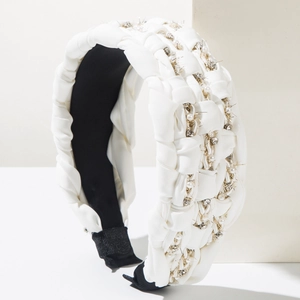 Detailed close-up of bohemian white silk braided headband with pearls and rhinestones