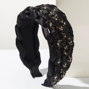 Detailed shot of bohemian braided satin headband with sparkling rhinestones and gold thread