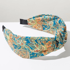 Detail of bohemian paisley print knotted headband with textured navy blue fabric