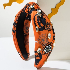 Detail of Halloween headband with orange spider web fabric and sparkling rhinestones