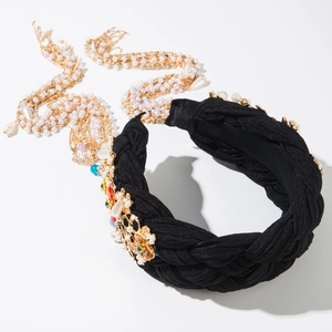 Detailaufnahme des geflochtenen Stoff-Stirnbands mit Goldblumen und bunten Perlenakzenten