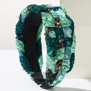 Detail of bohemian braided headband with green sequins and intricate hand-beaded pearls