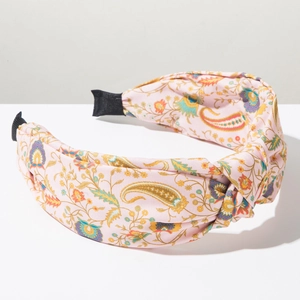 Detail of pink paisley floral headband featuring a bohemian wide knot design and soft texture
