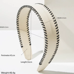 Detail view of cream leather headband with black stitching and dimensions 16x13cm