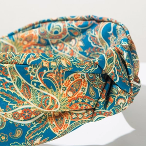 Close-up of bohemian blue paisley print wide headband knot detail with fabric texture