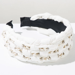 Detail of white braided headband with faux pearls, rhinestones and golden chains