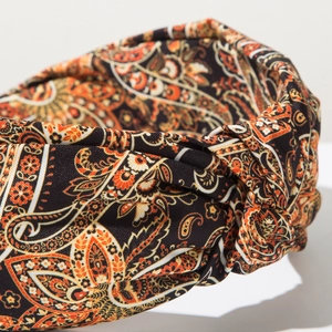 Macro detail of paisley print fabric and twisted knot on Bohemian wide headband