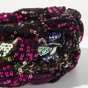 Macro detail of braided sequin headband featuring pink, gold, and blue sparkling accents