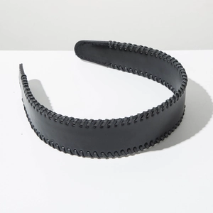 Detail of black wide leather headband with intricate whipstitch edging and sewing craft