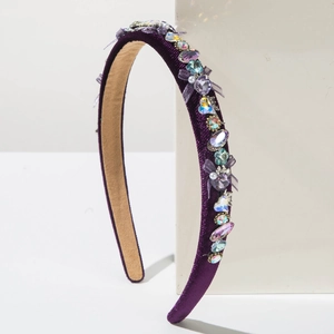 Detail of luxury purple velvet headband with hand-set colorful crystals and gems