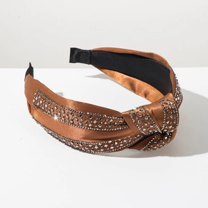 Close-up of caramel brown satin headband with sparkling silver rhinestones and top knot