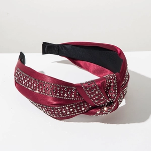 Detail of burgundy satin headband with knotted top and multiple rows of crystal rhinestones