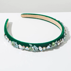 Detail of dark green velvet headband featuring crystal rhinestones and pearls inlay