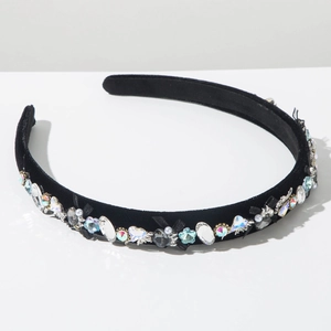 Detail of black velvet headband with colorful crystals, pearls and a handmade bow