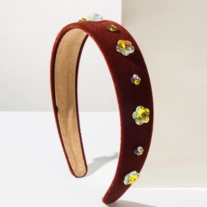 Detailed macro view of dark red velvet headband with colorful sparkling rhinestones