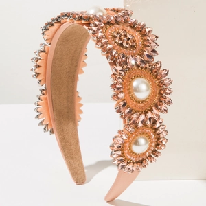 Detailed view of Baroque pink satin headband with floral rhinestone and pearl embellishments