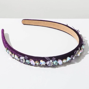 Detail of purple velvet headband featuring faux crystals and mesh bow decoration