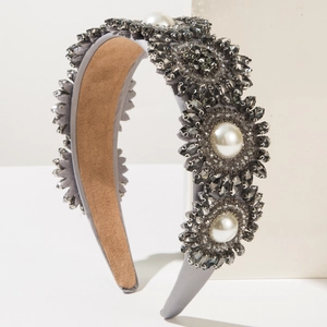 Detailed close-up of luxury Baroque headband with grey crystals and white pearls