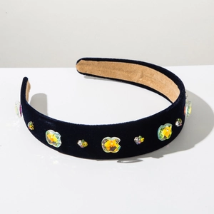 Detailed macro of dark blue velvet headband with multi-colored sparkling rhinestones