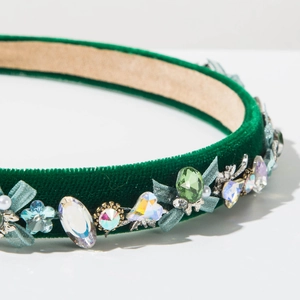 Detail of green velvet headband with hand-stitched crystals, mesh flowers and pearls