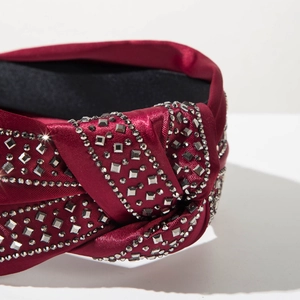 Detail of burgundy satin knot headband with hand-set sparkling rhinestones and crystals