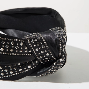 Detail of black satin headband with silver rhinestones and twisted knot design