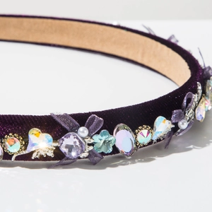 Close-up of velvet headband with crystal AB rhinestones and purple mesh bows
