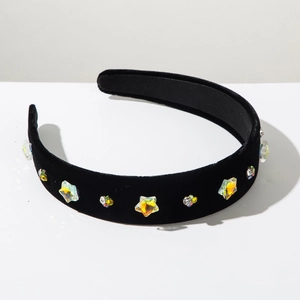 Detail showing black velvet headband with colorful crystal stars and sparkling rhinestones