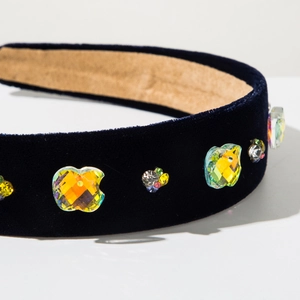 Macro detail of luxury baroque velvet headband with apple crystal and colorful rhinestones