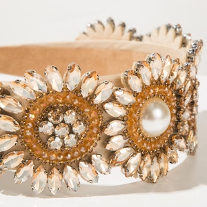 Macro detail of Baroque headband featuring sparkling crystals and a large central pearl