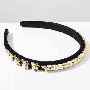 Close-up of golden bees and crystals on a black velvet baroque headband hairpiece