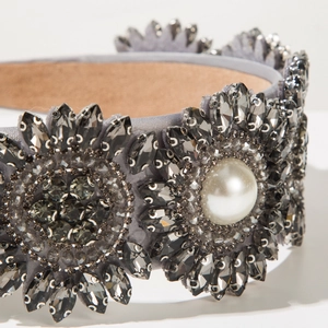 Detailed macro view of baroque headband with dark grey crystals and white pearl