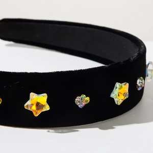 Detail of black velvet headband featuring colorful star-shaped rhinestones and crystals