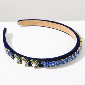 Close-up of luxury blue velvet headband with crystal jewels and pearl bee details