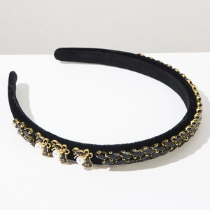 Detail of vintage velvet headband with golden bees, white pearls and black rhinestones
