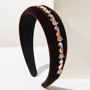 Detail of baroque velvet headband with sparkling crystals and golden floral accents