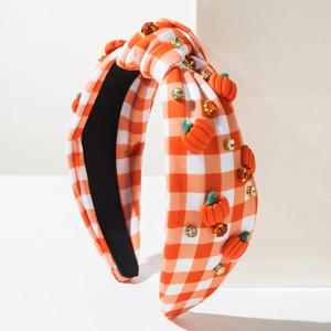 Detail of checkered headband with orange pumpkin charms and rhinestones for Thanksgiving