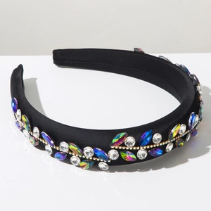Detail of baroque style sponge headband with colorful rhinestones on black satin fabric